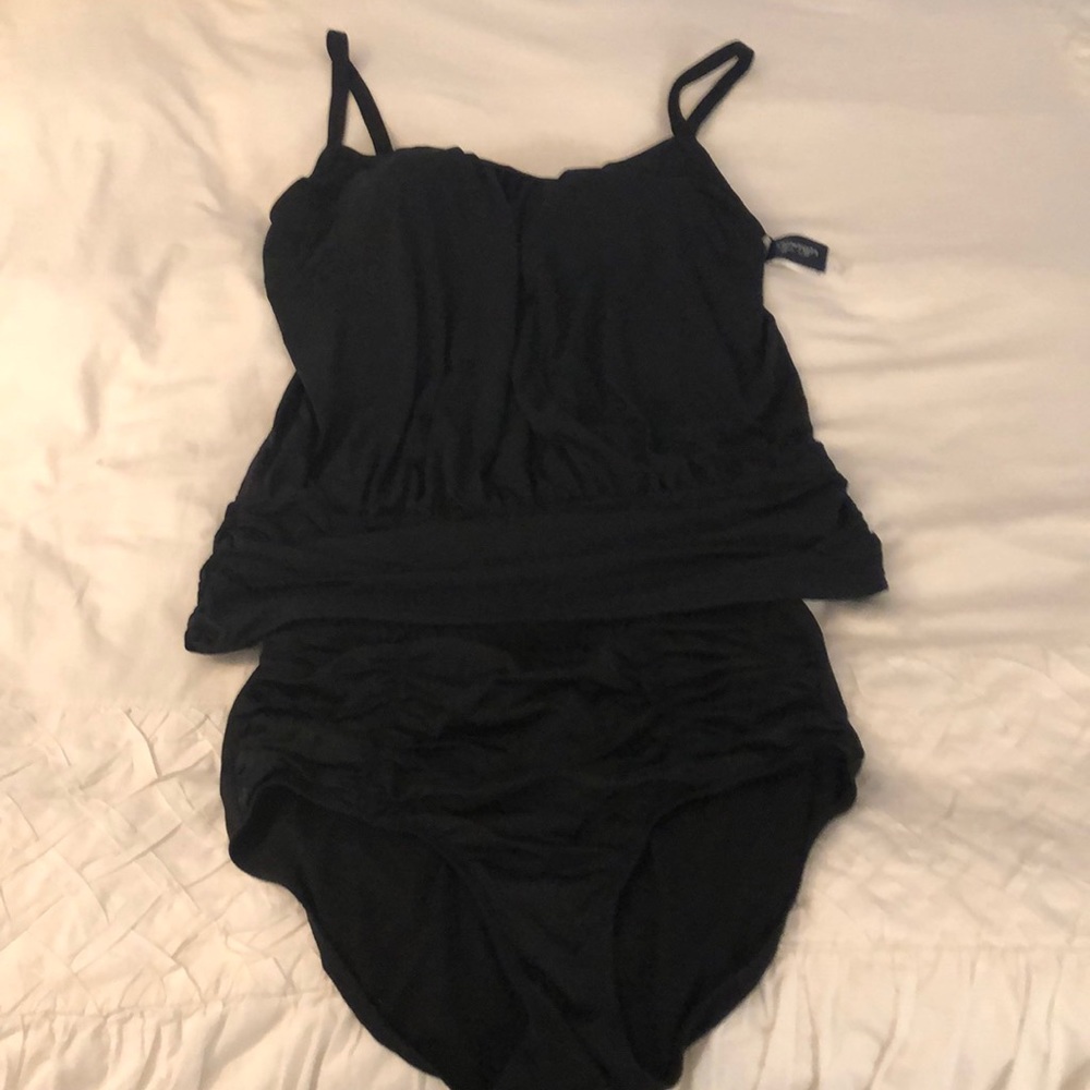Black tankini with blouson top and ruched bottoms.